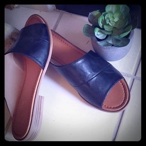 NWOT Black Leather asymmetrical flat shoes.